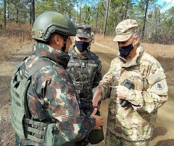 Maj. Gen. Daniel R. Walrath, right, U.S. Army South commanding general, greets a Brazilian Army soldier taking part in the bilateral training exercise at the Joint Readiness Training Center at Fort Polk, Louisiana, Feb. 2, as Lt. Gen. Marcos de Sá Affonso da Costa, chief of training, Land Forces Training Command, Exército Brasileiro, looks on.