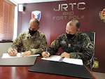 Maj. Gen. Daniel R. Walrath (left), Army South commanding general, and Lt. Gen. Marcos de Sá Affonso da Costa (right), chief of training, Land Forces Training Command, Exército Brasileiro, signs a technical arrangement between the Brazilian Army and the U.S. Army as represented by Army South concerning Brazilian participation in combined training exercise in conjunction with Joint Readiness Training Center Rotation 21-04 at Fort Polk, Louisiana, Feb. 1.