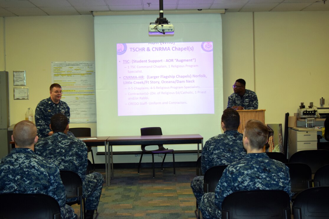 VIRGINIA BEACH, Va. (Feb. 4, 2018) Chaplain Lt. Cary Shinn, Training Support Center Hampton Roads, Command Chaplain and Religious Program Specialist 3rd Class Oluwadamilola Adeyemi brief students awaiting instruction on a weekly basis to ensure they stay active, volunteer and know where the nearest chapels/services are located.  These visits are designed to inform students on how they can better themselves, become leaders by getting involved all while improving their quality of life. (U.S. Navy photo by Robin Holland)