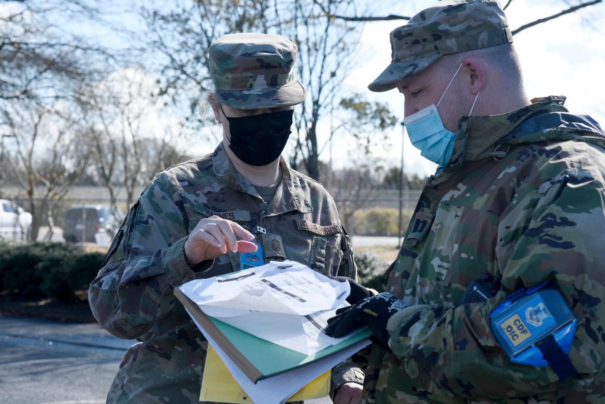U.S. Air Force Logistics Readiness Officer, Capt. Jack Hogue (right), 145th Logistics Readiness Squadron(LRS), speaks with Master Sgt. Patricia Haynes, 145th LRS, during a Cargo Deployment Function (CDF) exercise held at the North Carolina Air National Guard Base, Charlotte Douglas International Airport, Feb. 7, 2021. A CDF is similar to a personnel deployment line where you have a station to assemble items, check them for quality and to make sure they can safely be loaded onto an aircraft. Once the items are cleared to be loaded onto an aircraft, they reach the final phase of the CDF.