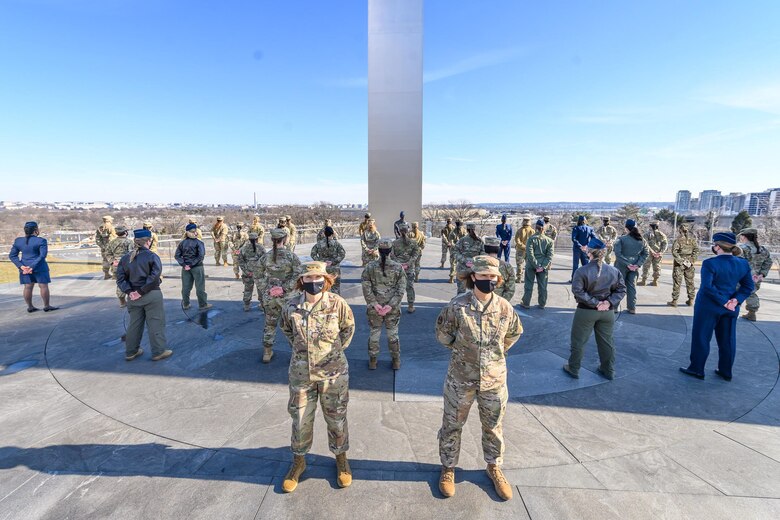 Lt. Gen. Mary F. O'Brien,deputy chief of staff for Intelligence, Surveillance, Reconnaissance and Cyber Effects Operations, and Chief Master Sgt. of the Air Force JoAnne S. Bass stand in front of a group of female Airmen demonstrating the Air Force's new hair policy for women in front of the Air Force Memorial, Jan. 24, 2021.