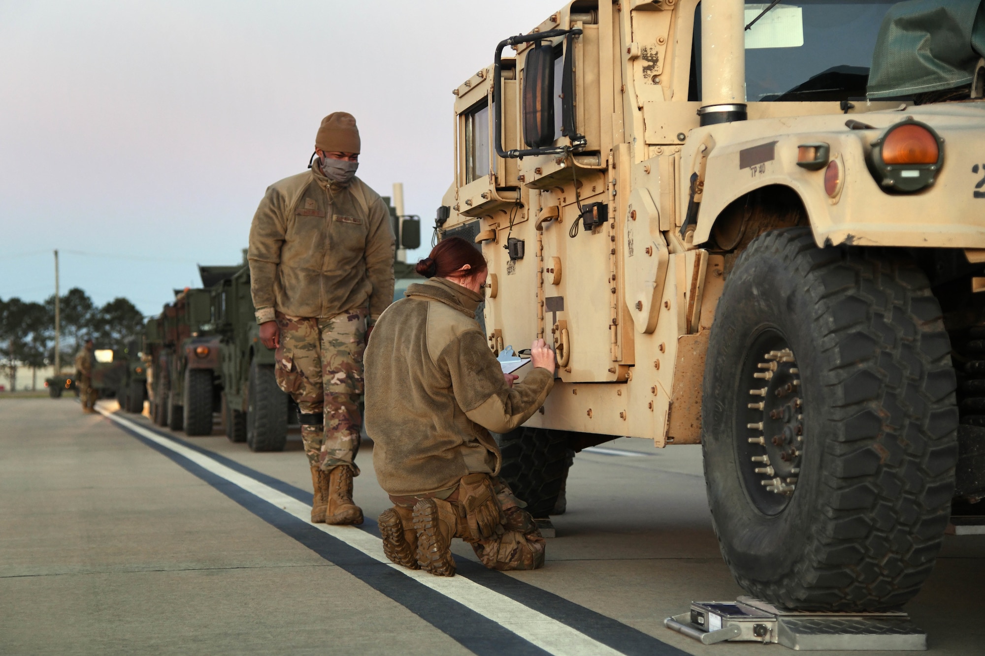 U.S. Air Force Airman Reannah Hilderbrandt, 321st Contingency Response Squadron aerial port contingency response specialist, annotates weights and measurements of a Humvee during a joint inspection Feb. 1, 2021, at Alexandria International Airport, Louisiana. Airmen from the 621st Contingency Response Group participated in a Joint Readiness Training Center exercise Jan. 31-Feb. 9 at the airport and a nearby landing zone. (U.S. Air Force photo by Master Sgt. Melissa B. White)