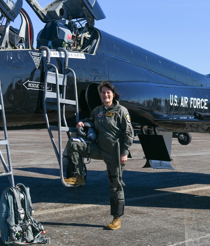 Brig. Gen. Patrice Melancon poses in front of an air craft