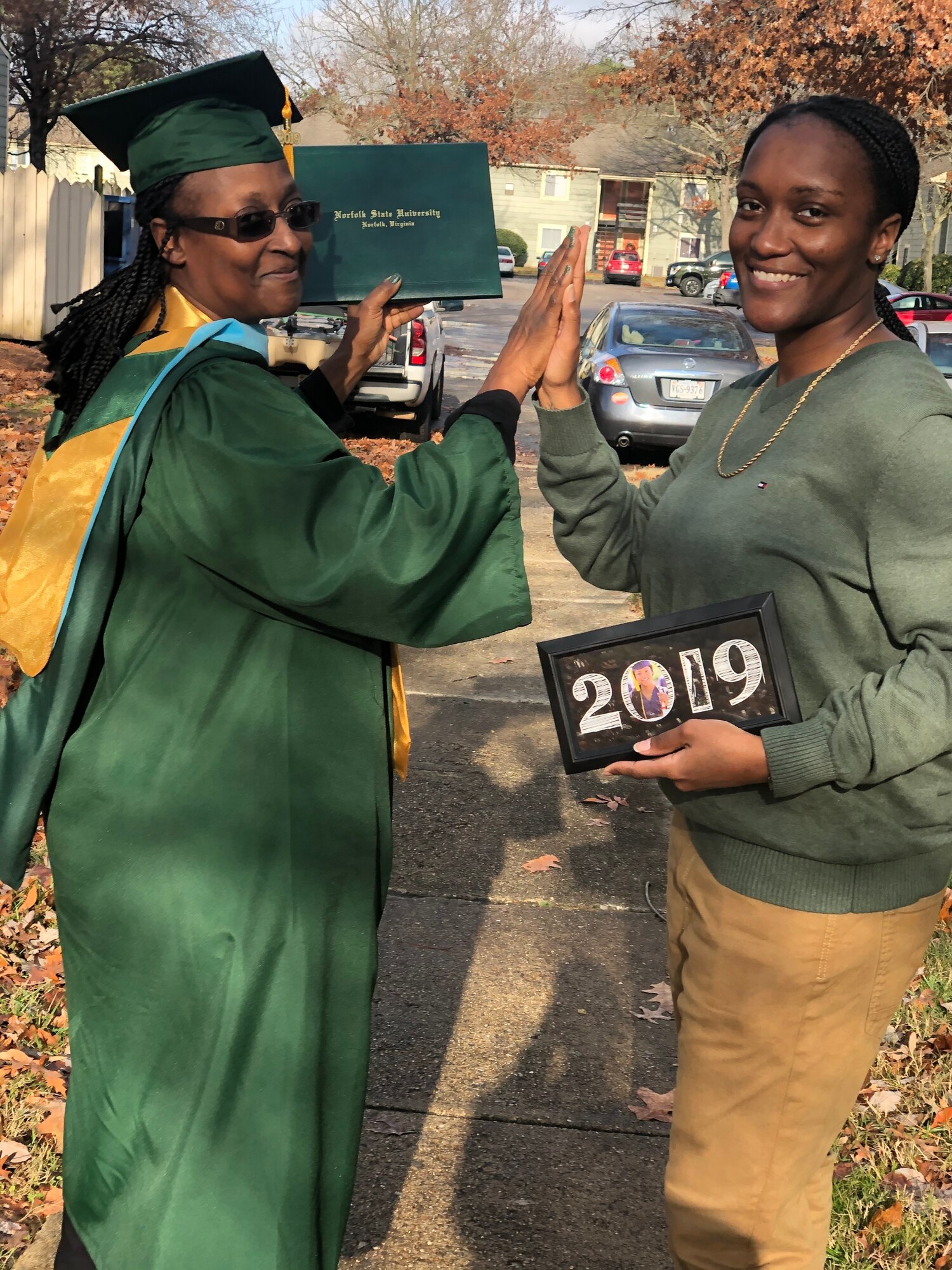 Two women smile for a graduation photo