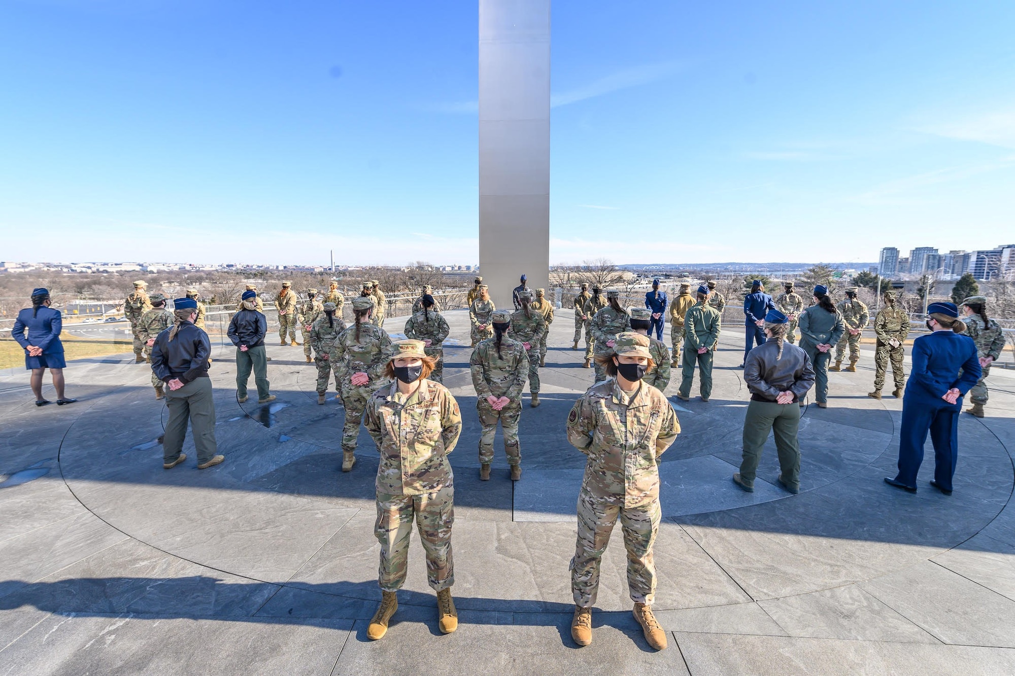 Lt. Gen. Mary F. O’Brien,deputy chief of staff for Intelligence, Surveillance, Reconnaissance and Cyber Effects Operations, and Chief Master Sgt. of the Air Force JoAnne S. Bass stand in front of a group of female Airmen demonstrating the Air Force’s new hair policy for women in front of the Air Force Memorial Jan. 24. (US. Air Force photo by Master Sgt. Grant Langford)