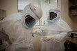 Two lab technicians dress in PPE