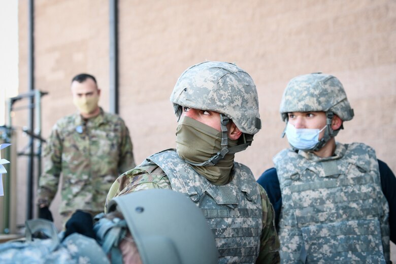 Airman 1st Class Bradli Badali, a 460th Medical Group aerospace medical technician, looks up at an instructor during the Tactical Combat Casualty Care exercise on Buckley Air Force Base, Colo., Feb. 4, 2021.