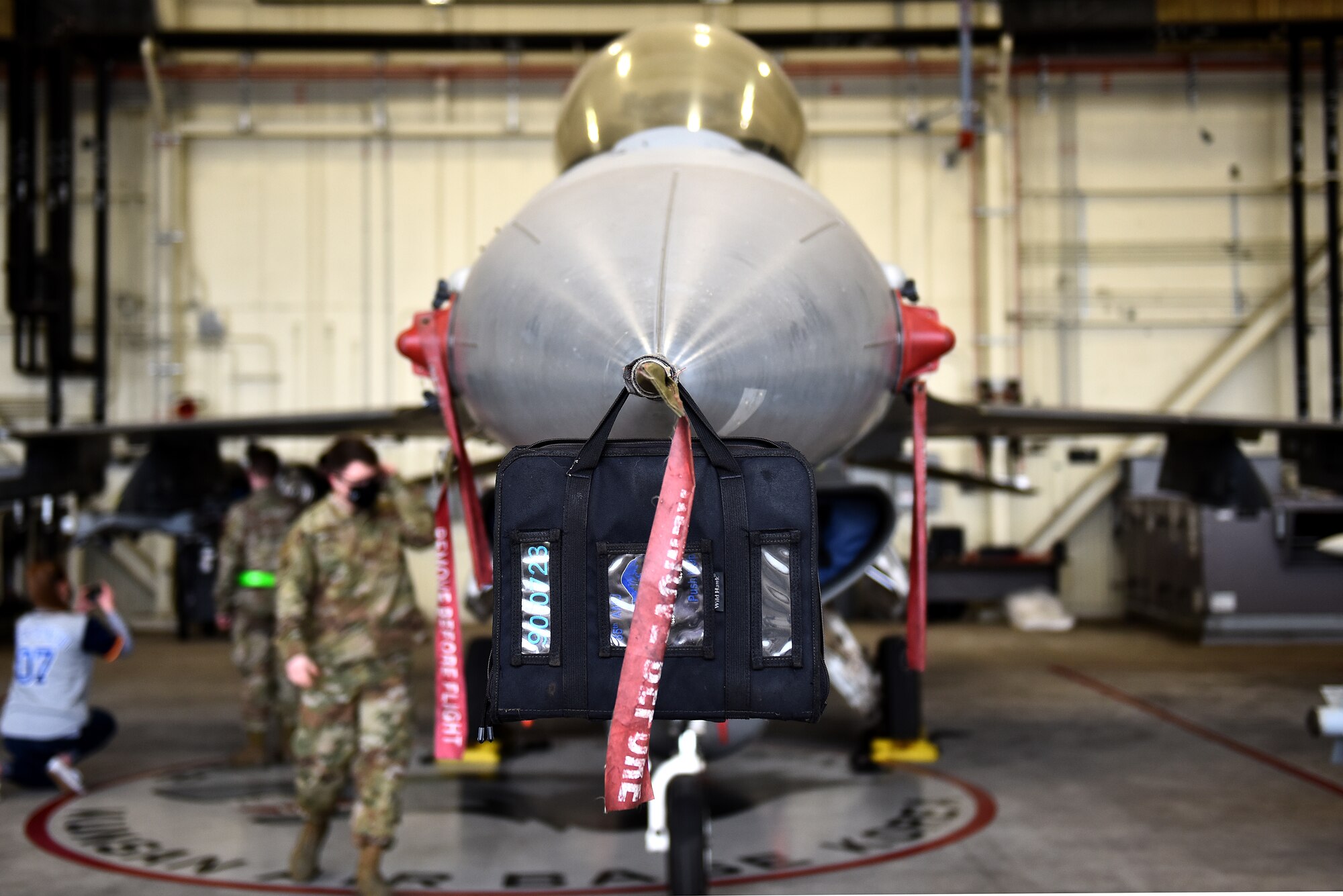 Airmen from the 8th Maintenance Squadron survey an F-16 Fighting Falcon prior to the Annual Load Crew Competition at Kunsan Air Base, Republic of Korea, Feb. 6, 2021. Three teams completed in four categories to include dress and appearance, a weapons knowledge test, a toolbox inspection and a weapons load. (U.S. Air Force photo by Senior Airman Suzie Plotnikov)
