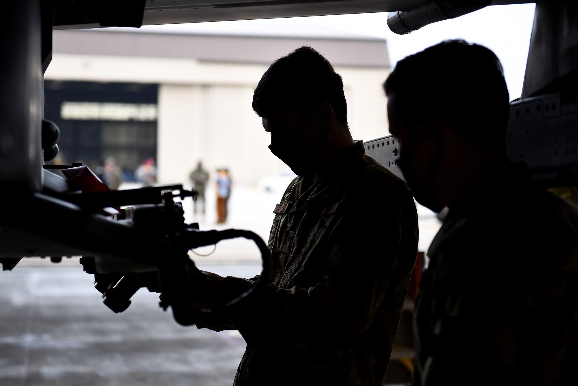 Senior Airman Merlin Reiland, 8th Maintenance Squadron load crew team member, and Staff Sgt. Brian Thompson, 8th MXS load crew team chief, survey an F-16 Fighting Falcon prior to the Annual Load Crew Competition at Kunsan Air Base, Republic of Korea, Feb. 6, 2021. Three teams completed in four categories to include dress and appearance, a weapons knowledge test, a toolbox inspection and a weapons load. (U.S. Air Force photo by Senior Airman Suzie Plotnikov)