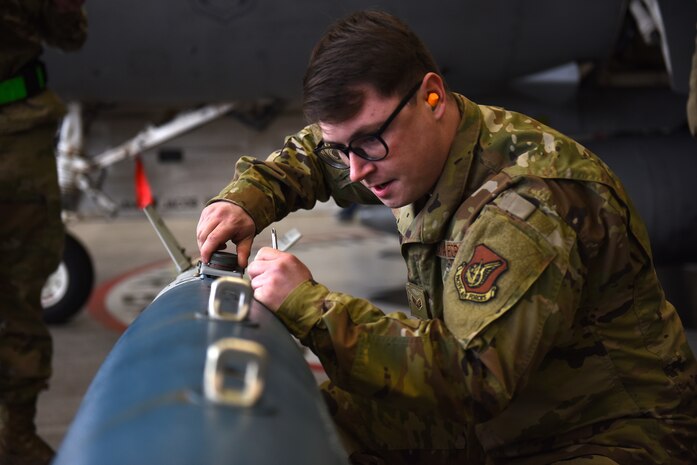 Senior Airman Dustin Barrett, 8th Maintenance Squadron load crew team member, secures a Joint Direct Attack Munition, or JDAM, during the Annual Load Crew Competition at Kunsan Air Base, Republic of Korea, Feb. 6, 2021. Three teams completed in four categories to include dress and appearance, a weapons knowledge test, a toolbox inspection and a weapons load. (U.S. Air Force photo by Senior Airman Suzie Plotnikov)