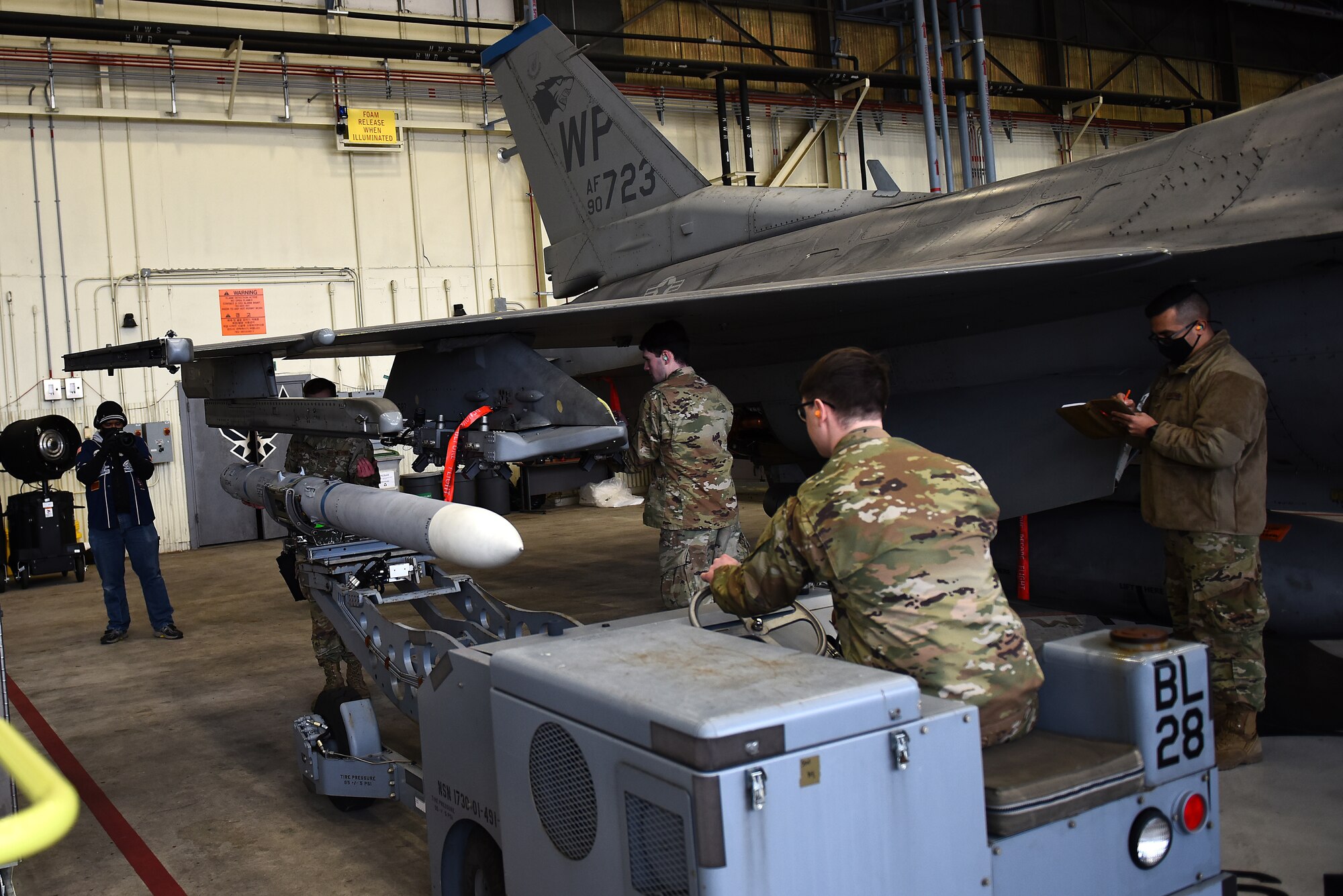 The Armament Flight, 8th Maintenance Squadron, loads an AIM 9 L/M Sidewinder on an F-16 Fighting Falcon during the Annual Load Crew Competition at Kunsan Air Base, Republic of Korea, Feb. 6, 2021. Three teams completed in four categories to include dress and appearance, a weapons knowledge test, a toolbox inspection and a weapons load. (U.S. Air Force photo by Senior Airman Suzie Plotnikov)