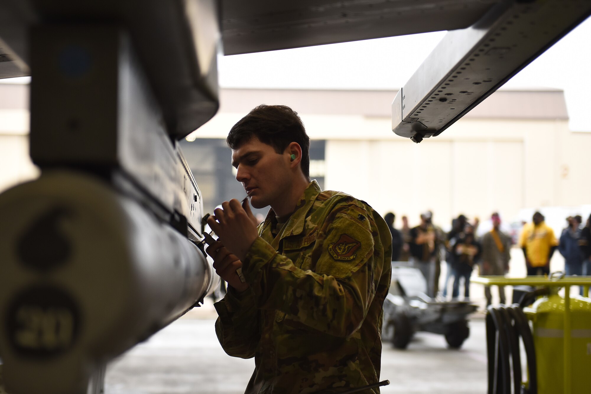 Senior Airman Merlin Reiland, 8th Maintenance Squadron load crew team member, loads an AIM 9 L/M Sidewinder on an F-16 Fighting Falcon during the Annual Load Crew Competition at Kunsan Air Base, Republic of Korea, Feb. 6, 2021. Three teams completed in four categories to include dress and appearance, a weapons knowledge test, a toolbox inspection and a weapons load. (U.S. Air Force photo by Senior Airman Suzie Plotnikov)