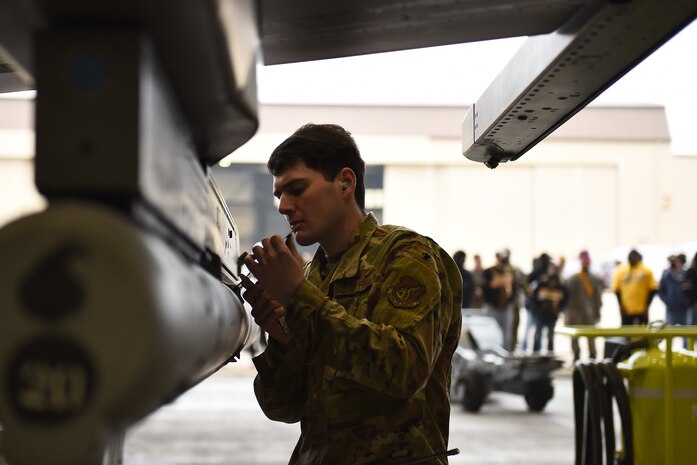 Senior Airman Merlin Reiland, 8th Maintenance Squadron load crew team member, loads an AIM 9 L/M Sidewinder on an F-16 Fighting Falcon during the Annual Load Crew Competition at Kunsan Air Base, Republic of Korea, Feb. 6, 2021. Three teams completed in four categories to include dress and appearance, a weapons knowledge test, a toolbox inspection and a weapons load. (U.S. Air Force photo by Senior Airman Suzie Plotnikov)