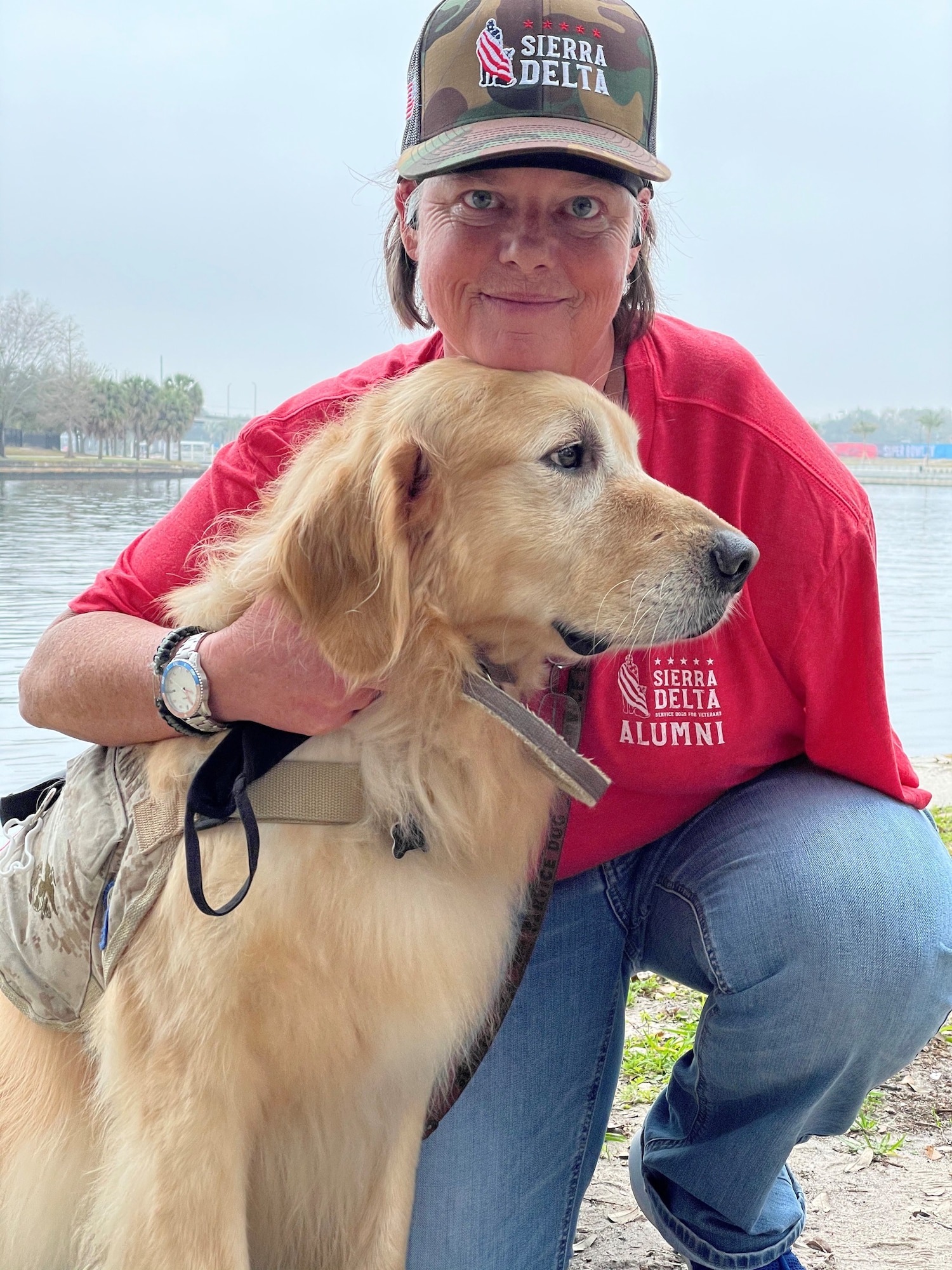 Kelly Smith, a U.S. Navy veteran, holds her service dog, Cook, following the ‘Salute-To-Service-Stroll’ Feb. 6, 2021, at the Tampa Riverwalk, Tampa, Florida. Smith and Cook have been soulmates for five years. (U.S. Army photo by Spc. Robert Vicens)