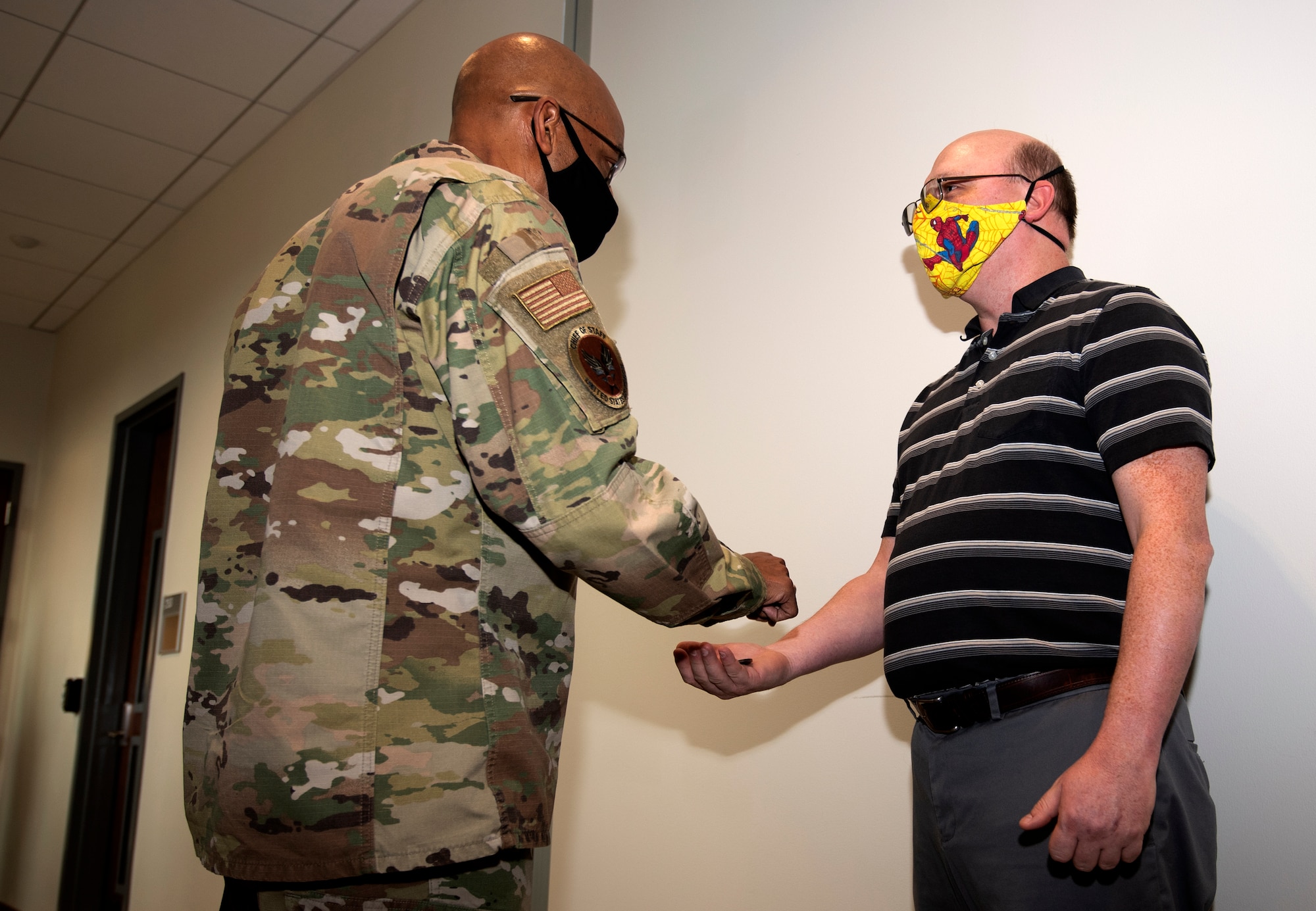 Air Force Chief of Staff, Gen. Charles Q. Brown, Jr. presents Lee Ricker, a senior personnel systems analyst in the Directorate of Manpower, Personnel and Services, a coin for his efforts towards COVID-19, at Air Force Reserve Command headquarters on Robins Air Force Base in Georgia on Feb. 8, 2021. While at the headquarters, Brown discussed COVID-19 response efforts, diversity and inclusion issues, readiness, and the role of the Air Force Reserve in the future fight. (U.S. Air Force photo by Master Sgt. Stephen D. Schester)