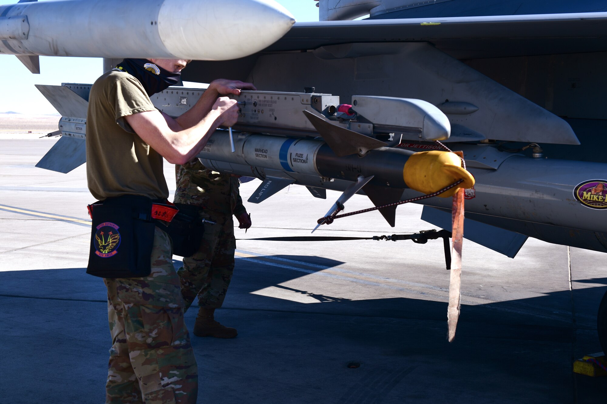 Senior Airman Kaleb Moyer, 926th Aircraft Maintenance Squadron, removes a weapon from an F-16, Feb. 6, at Nellis Air Force Base, Nevada.