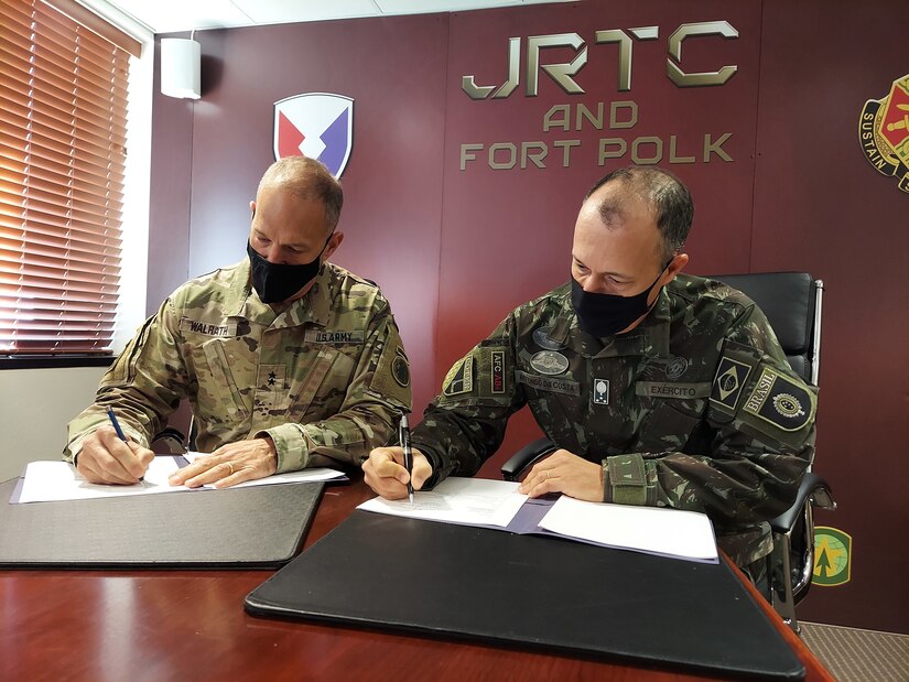 Maj. Gen. Daniel R. Walrath (left), Army South commanding general, and Lt. Gen. Marcos de Sá Affonso da Costa (right), chief of training, Land Forces Training Command, Exército Brasileiro, signs a technical arrangement between the Brazilian Army and the U.S. Army as represented by Army South concerning Brazilian participation in combined training exercise in conjunction with Joint Readiness Training Center Rotation 21-04 at Fort Polk, Louisiana, Feb. 1.