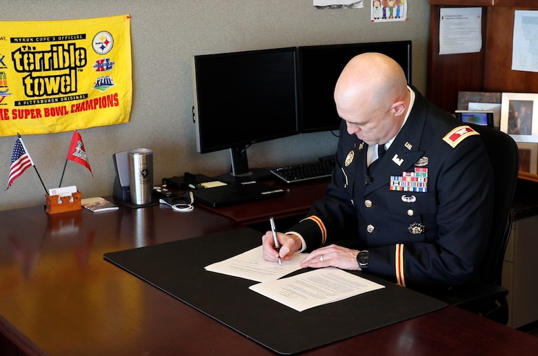 U.S. Army Corps of Engineers, Omaha District Commander Col. Mark Himes signs a Section 1176 project agreement Tuesday that will allow the District to raise the Hamburg Ditch 6 levee eight feet, significantly increasing the flood risk management benefits the levee provides to the city.