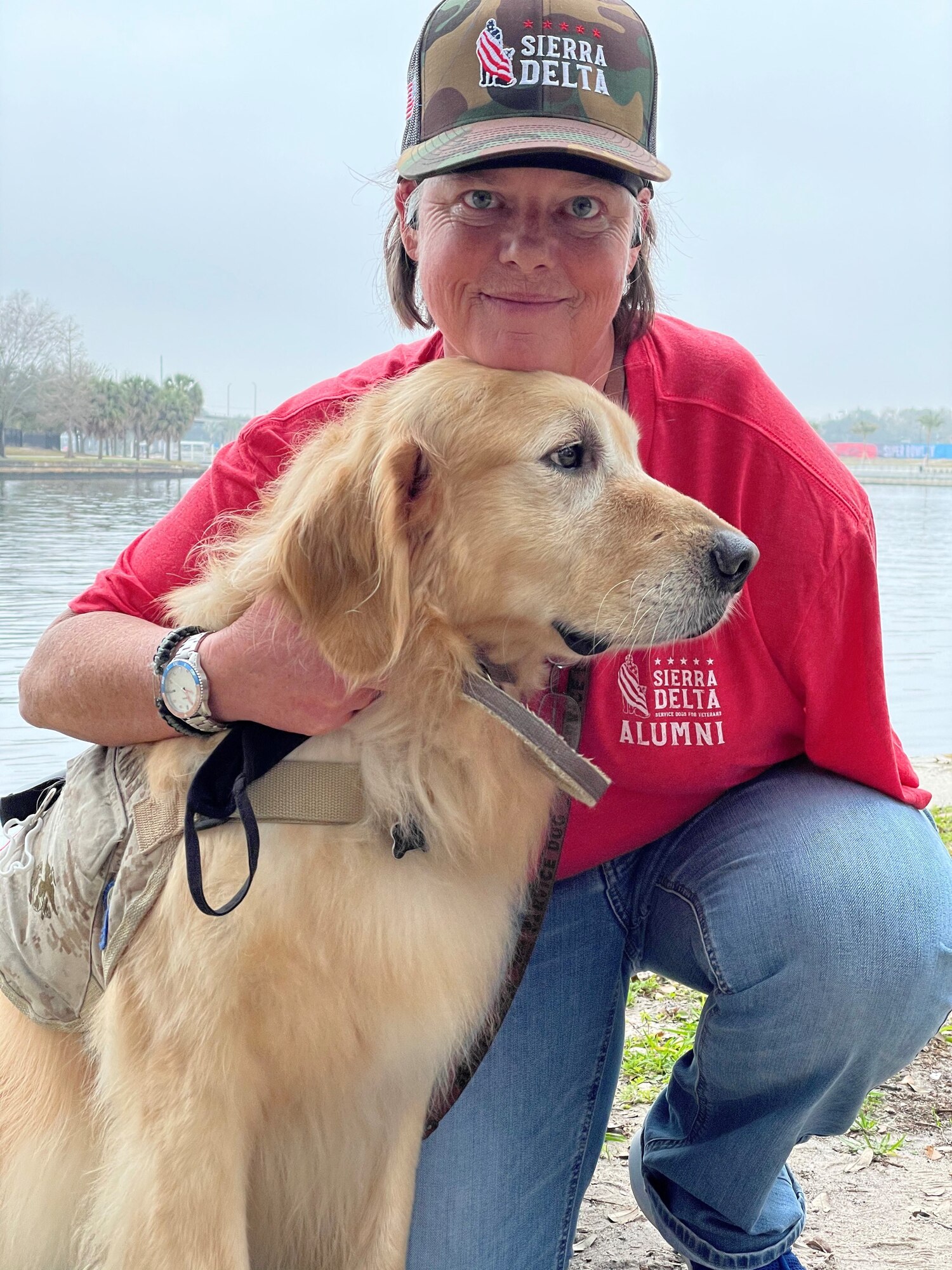 Kelly Smith, a U.S. Navy veteran, holds her service dog, Cook, following the ‘Salute-To-Service-Stroll’ Feb. 6, 2021, at the Tampa Riverwalk, Tampa, Florida. Smith and Cook have been soulmates for five years. (U.S. Army photo by Spc. Robert Vicens)