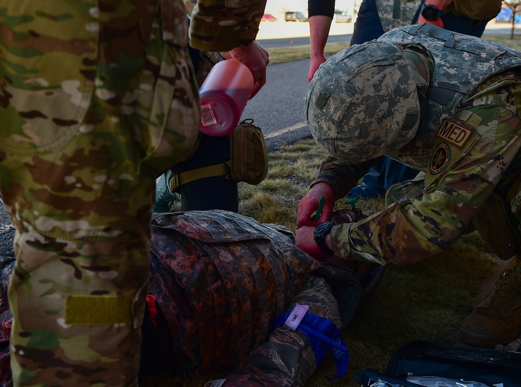 A medic participating in the 2021 Tactical Combat Casualty Care exercise creates an incision in the neck of a medical manikin to open its airway on Buckley Air Force Base, Colo., Feb. 4, 2021.
