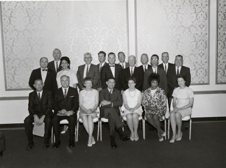 a group of people sitting and standing