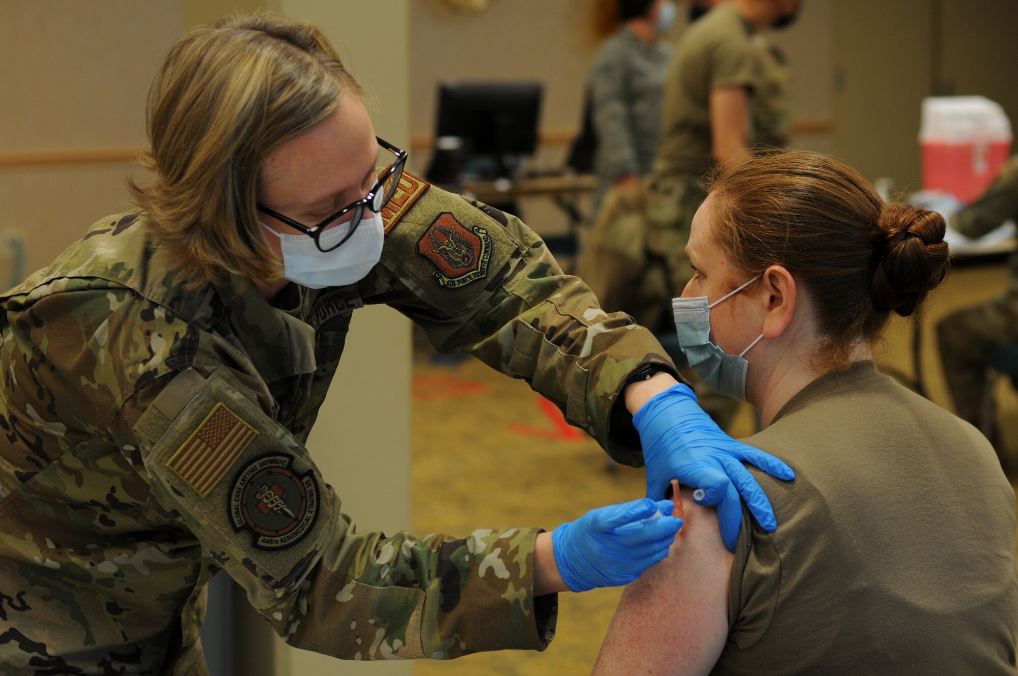U.S. Air Force Tech. Sgt. Rosemary Nantz, a Reserve Citizen Airman with the 446th Aeromedical Staging Squadron, receives her first dose of the Moderna COVID-19 vaccine from Tech. Sgt. Sarah Hora, an Air Force Reserve medical technician with the 446th Aeromedical Staging Squadron, at Joint Base Lewis-McChord, Washington, Feb. 6, 2021