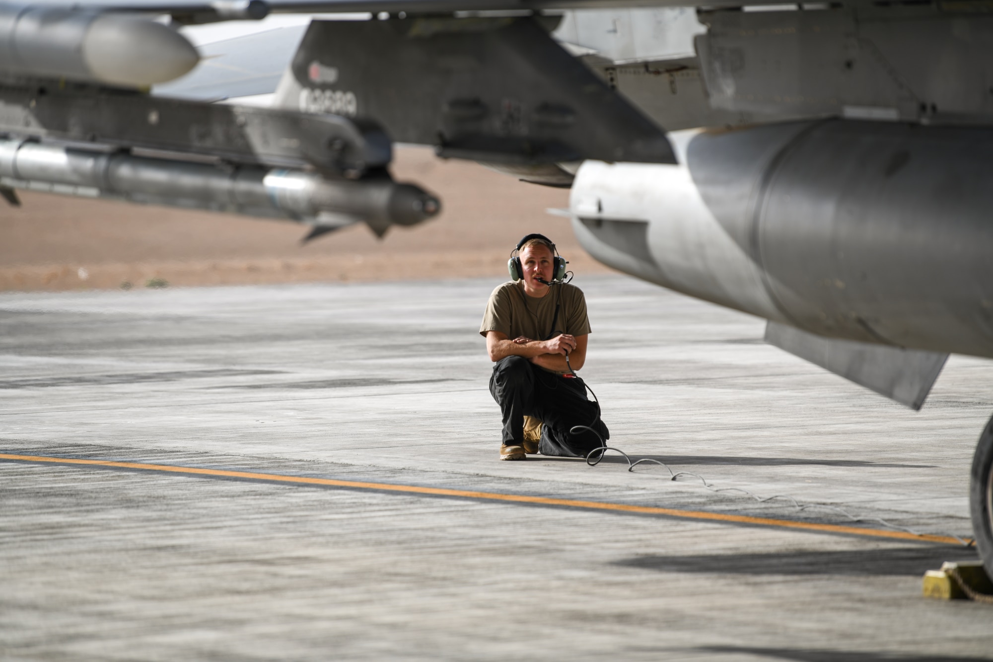 Senior Airman Massey, 77th Fighter Generation Squadron crew chief, performs a pre-flight inspection of an F-16C Fighting Falcon, Feb. 2, 2021, at King Faisal Air Base, Kingdom of Saudi Arabia.