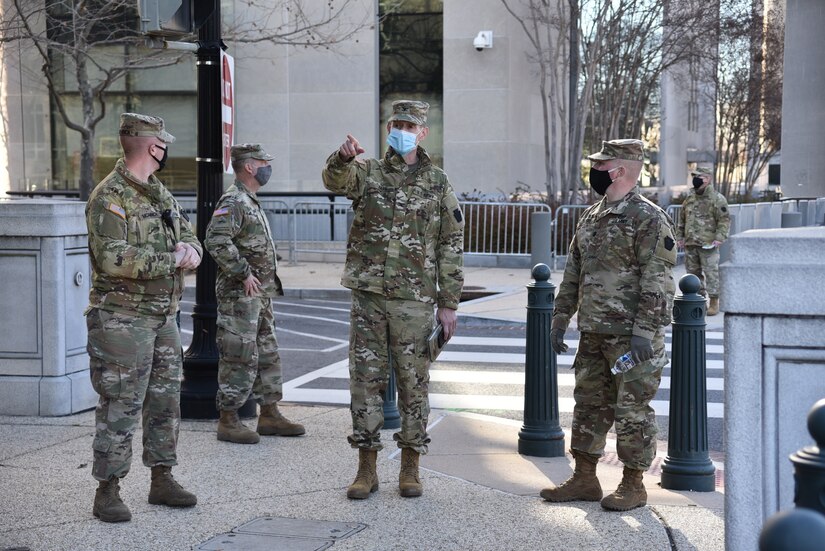 Col. Jon Farr, 56th Stryker Brigade Combat Team commander, inspects socially distanced security perimeters with Lt. Col. Adams, 2nd Squadron, 104th Cavalry Regiment, Pennsylvania Army National Guard in Washington, D.C., on Jan. 10, 2021.