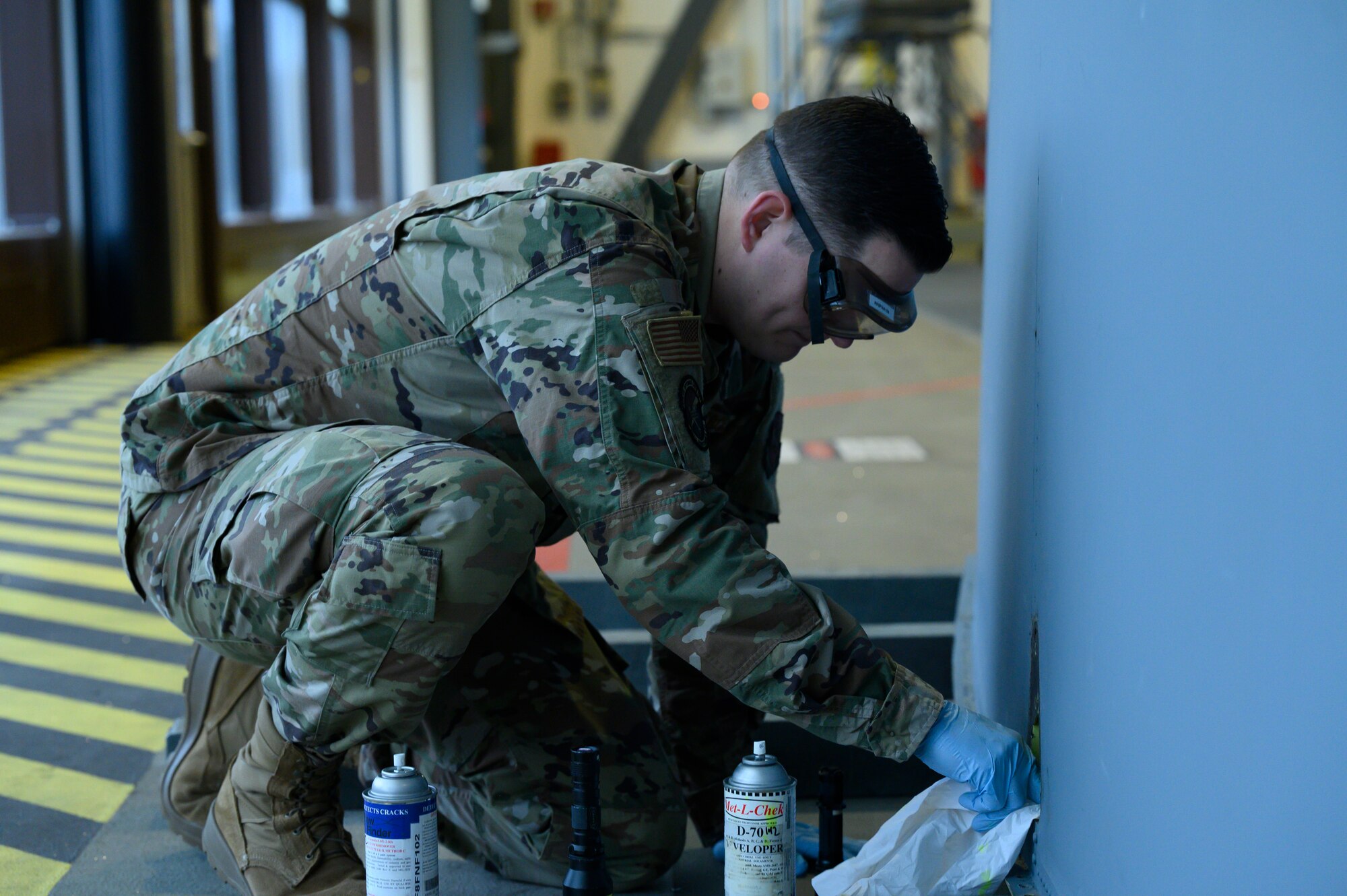 An Airman inspects the tail of a C-130J.