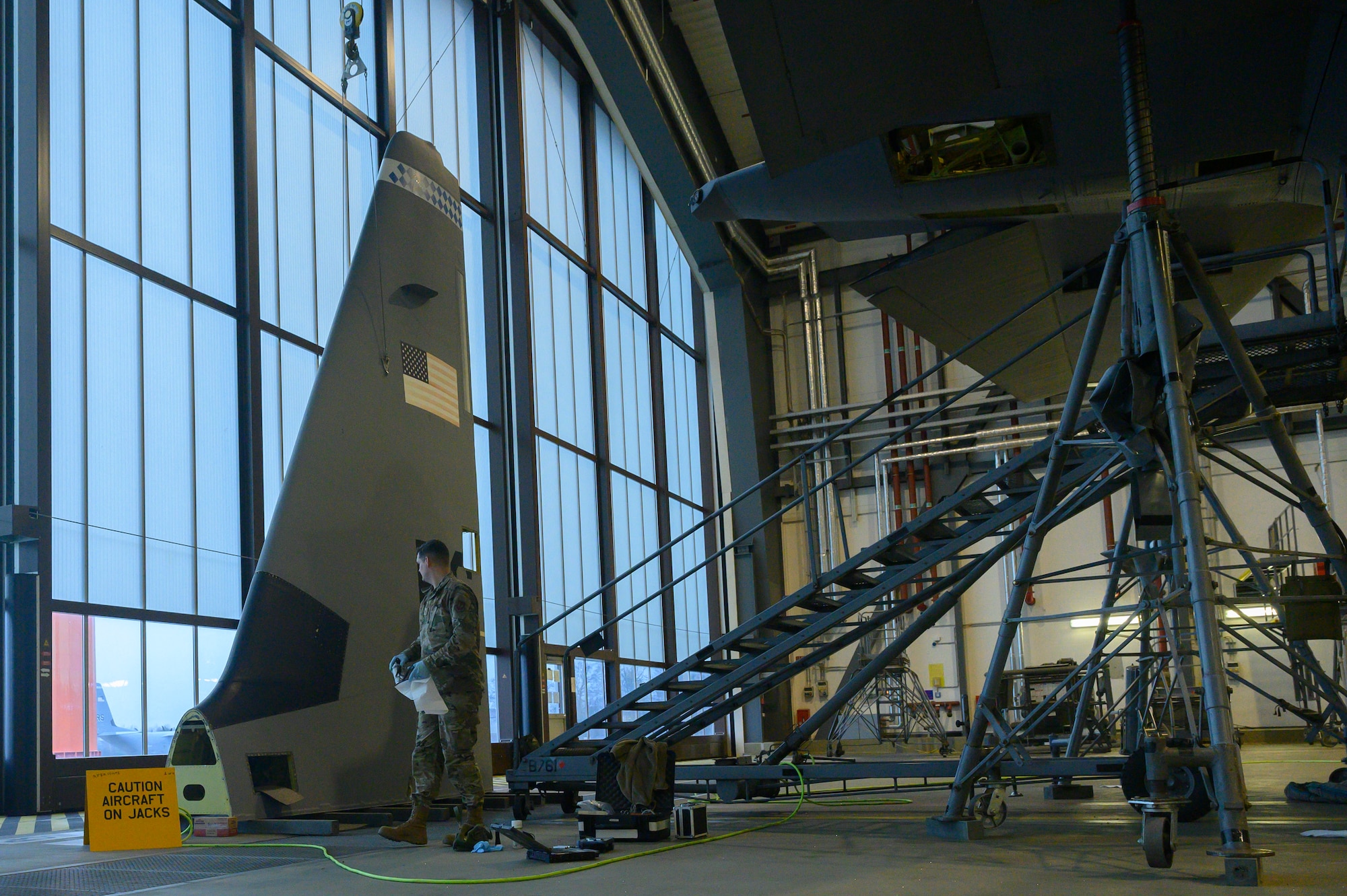 An Airman examines a C-130 tail.