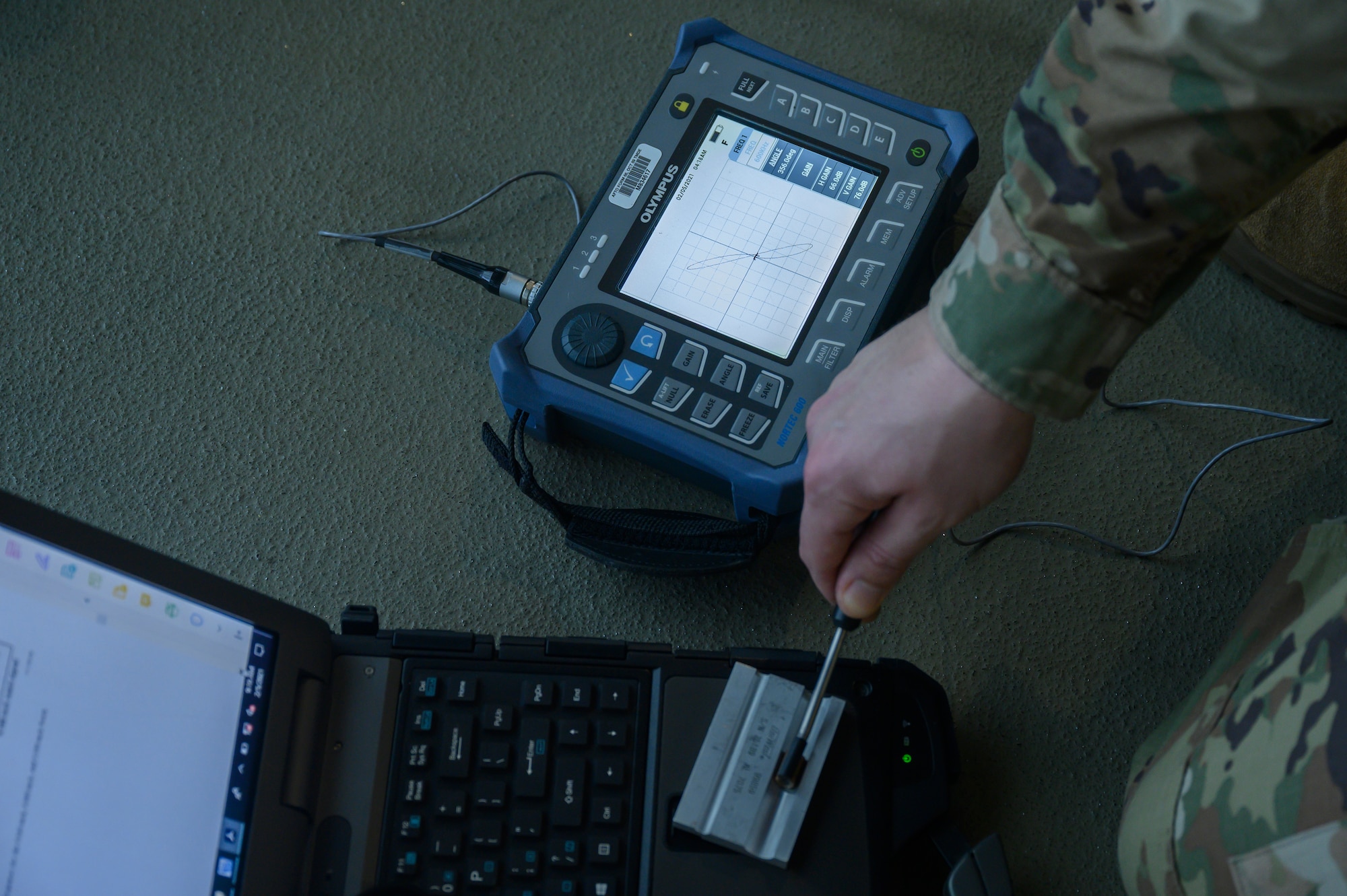 An Airman prepares an eddy current ribbon probe for inspection.