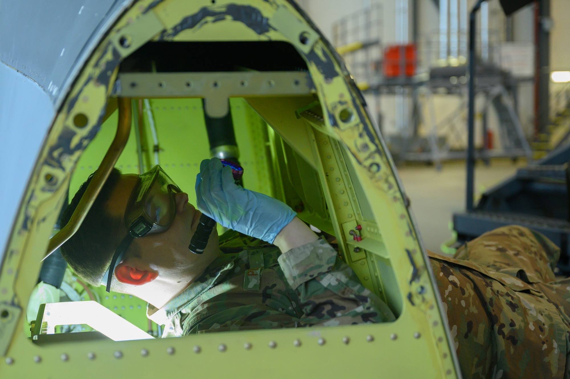 An Airman inspects the interior of a C-130.