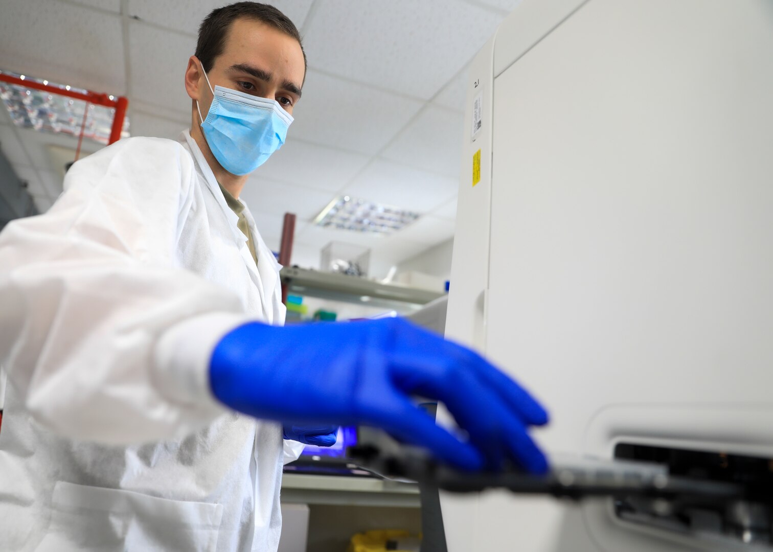 Capt. Cole Anderson, chief, Microbiology, Landstuhl Regional Medical Center, prepares a plate of COVID-19 specimens for testing with a Polymerase Chain Reaction (PCR) analyzer at LRMC’s Infectious Disease Laboratory, Feb. 10. Landstuhl Regional Medical Center recently surpassed 100,000 COVID-19 tests since its first test on March 6, 2020.