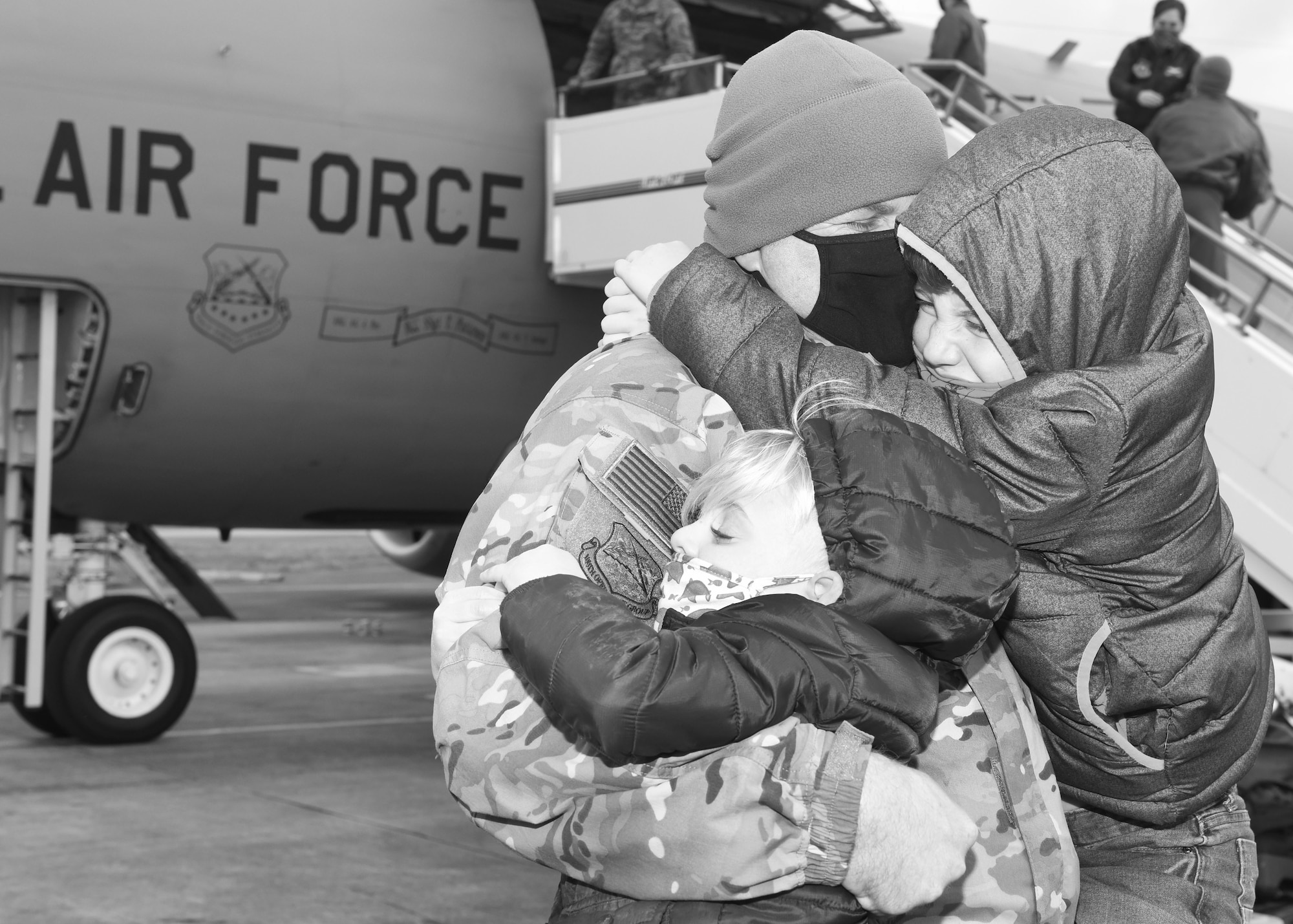 U.S. Air Force Maj. Tom Risner, 100th Operations Group chief of standardization and evaluation, hugs his sons Wyatt, 4, and Ryder, 8, after returning from a short-notice mission to support U.S. Central Command forces Feb. 1, 2021, at Royal Air Force Mildenhall, England. Airmen from the 100th Operations Group and 100th Maintenance Group provided vital support which enabled CENTCOM forces to support Operation Octave Quartz, and ensured the continued support of Operation Inherent Resolve. (U.S. Air Force photo by Karen Abeyasekere)