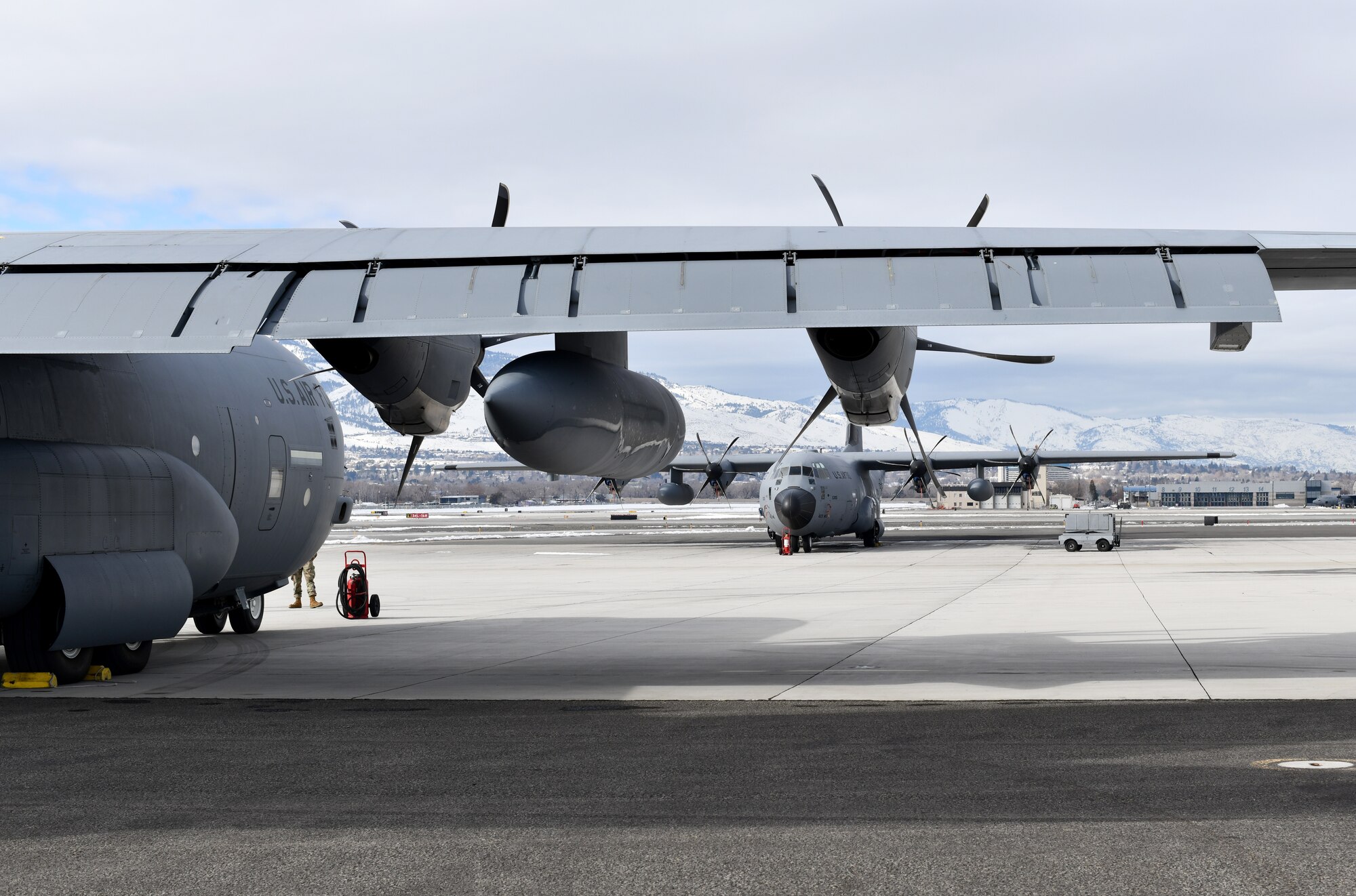 Two 53rd Weather Reconnaissance Squadron WC-130J aircraft sit adjacent from each other at Reno-Tahoe International Airport Jan. 31, 2021. The 53rd WRS is part of the Air Force Reserve's 403rd Wing at Keesler Air Force Base, Miss. (U.S. Air Force photo by Staff Sgt. Kristen Pittman)