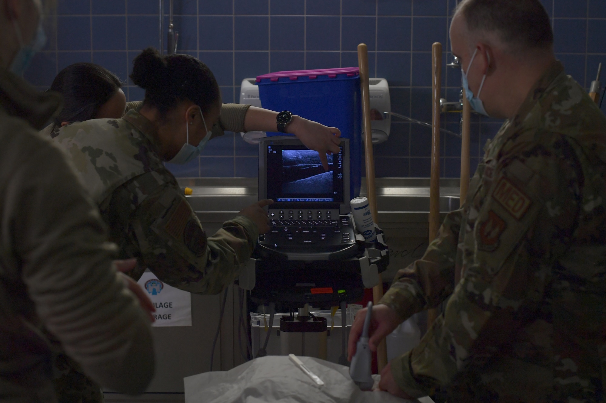 Airmen using an ultrasound machine.
