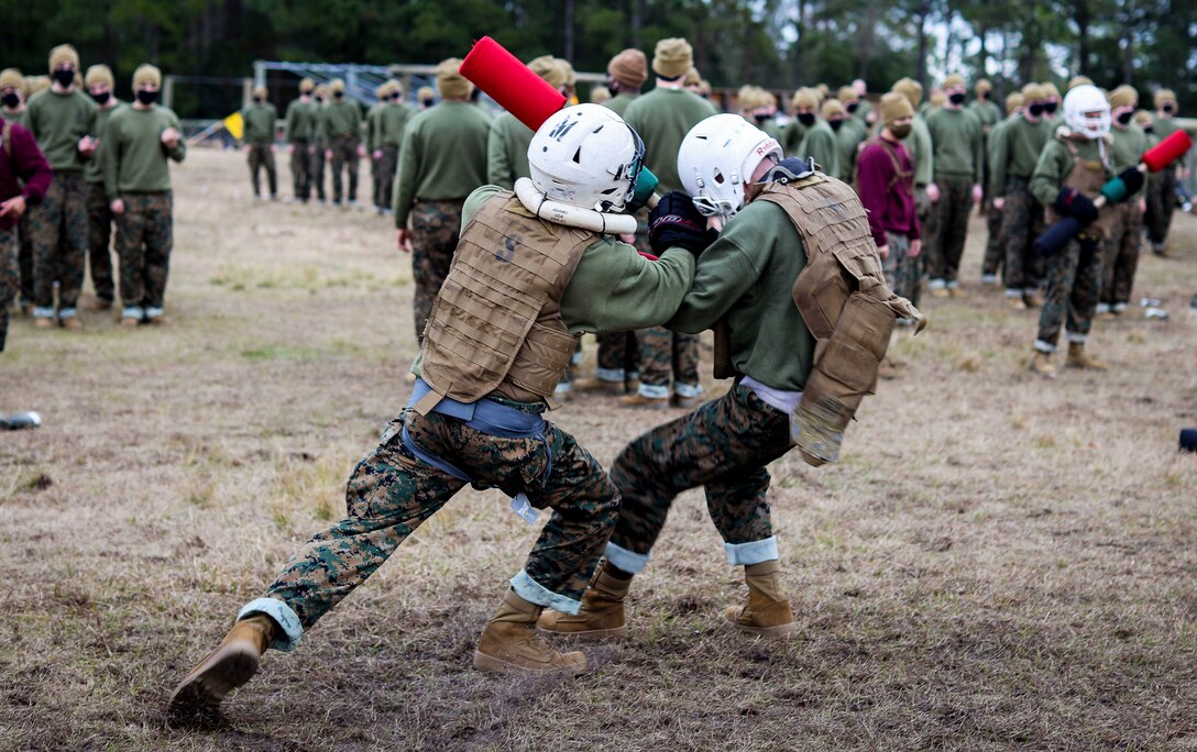 Recruits with Papa Company, 4th Recruit Training Battalion, conduct pugil sticks bouts aboard Marine Corps Recruit Depot Parris Island, S.C. Jan. 11, 2021. Pugil sticks help recruits practice the fundamentals of Marine Corps Martial Arts. (U.S. Marine Corps photo by Cpl. Dylan Walters)