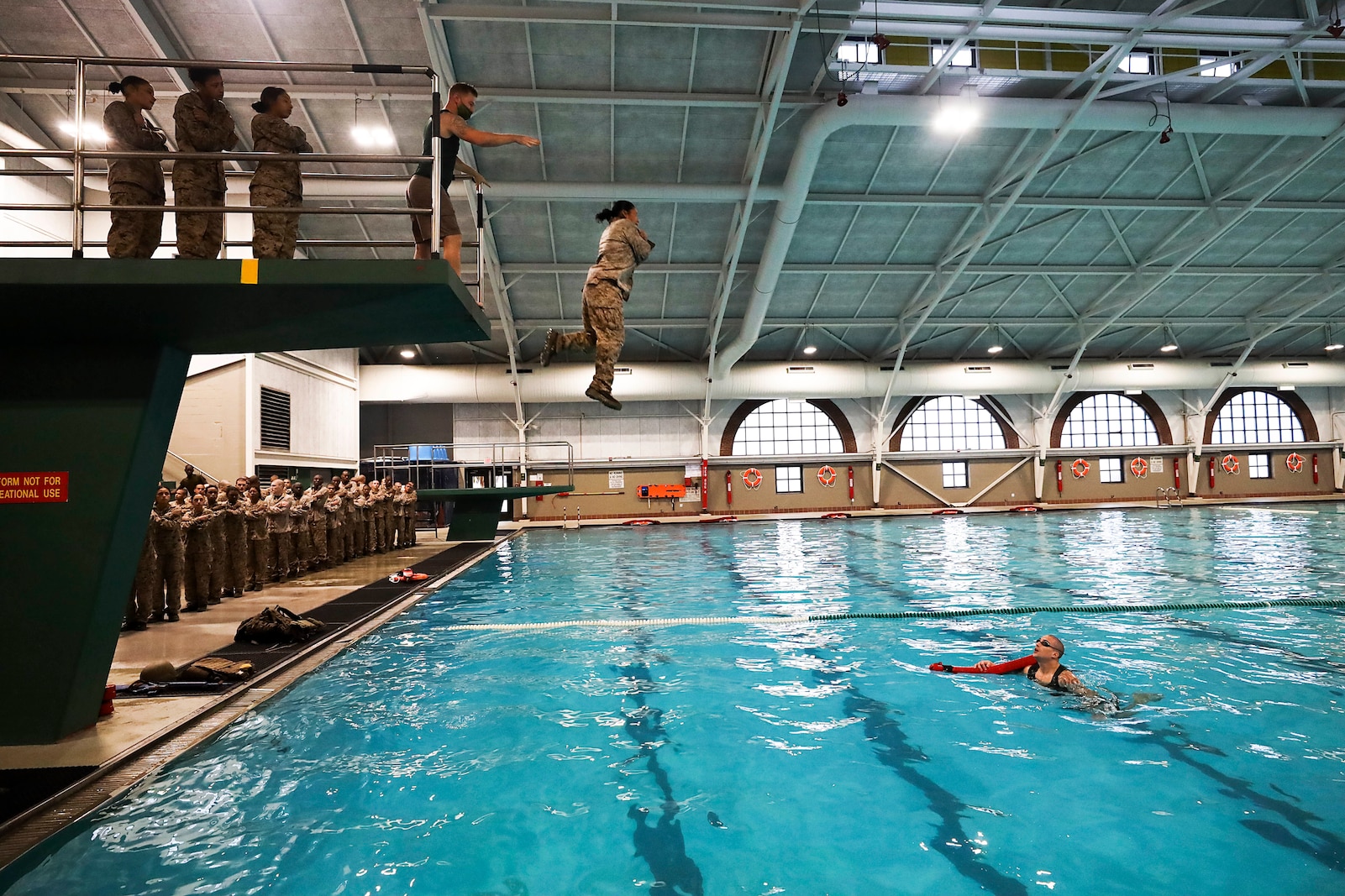A recruit with November Company, 4th Recruit Training Battalion, jumps off the tower during basic swim qualification aboard Marine Corps Recruit Depot Parris Island, S.C. Jan. 13, 2021. The tower is used to simulate aborting a ship at sea and is followed by a 25 meter swim. (U.S. Marine Corps photo by Lance Cpl. Samuel C. Fletcher)