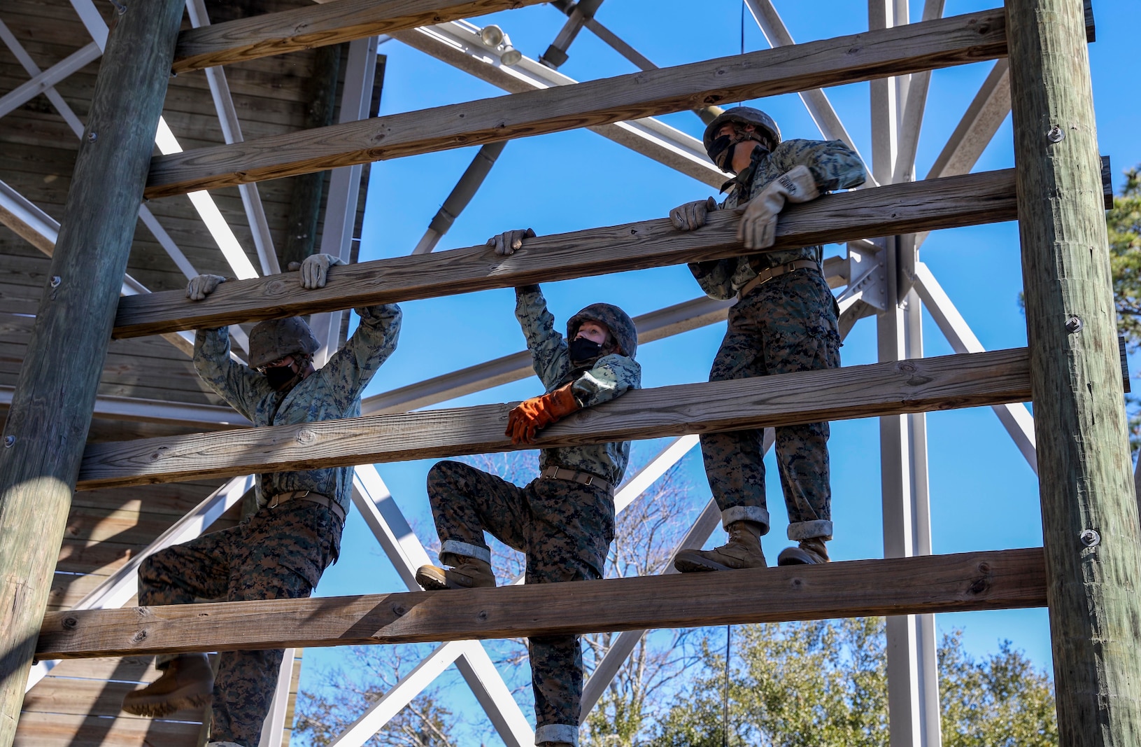Recruits with Papa Company, 4th Recruit Training Battalion, learn how to properly rappel from the rappel tower at Marine Corps Recruit Depot Parris Island, S.C., Jan. 19, 2021. The rappel tower is used to teach the recruits to overcome fear and trust their equipment. (U.S. Marine Corps photo by Lance Cpl. Godfrey Ampong)