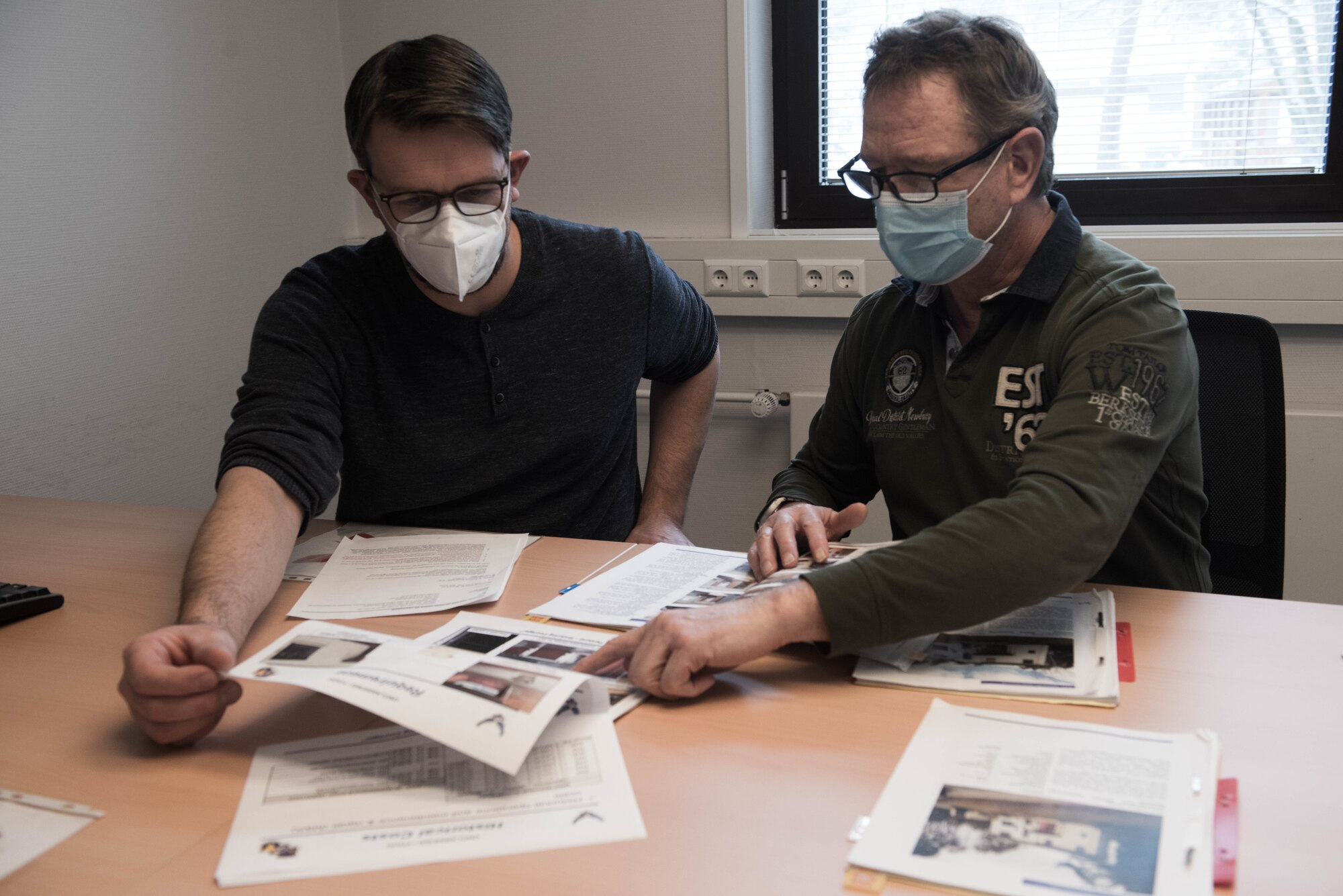 Holger Kehrer, 86th Civil Engineer Squadron engineering flight programs specialist, left, discusses future projects with his supervisor at Ramstein Air Base Germany, Feb. 4, 2021.