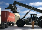 Teresa Cowell operates a rough terrain container handler to move a container that arrived Jan. 27 at the Battle Creek Michigan Air National Guard Base.