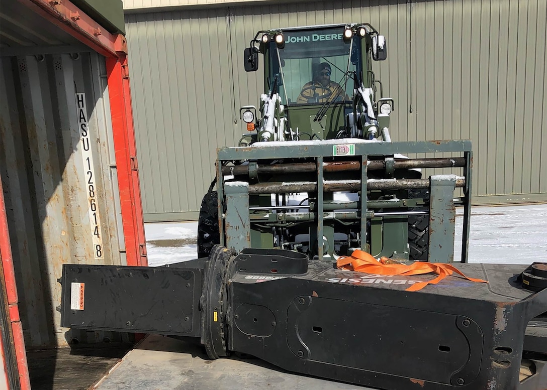 Chris Milazzo operates a forklift bearing a shearing device fastened to an airlift pallet.