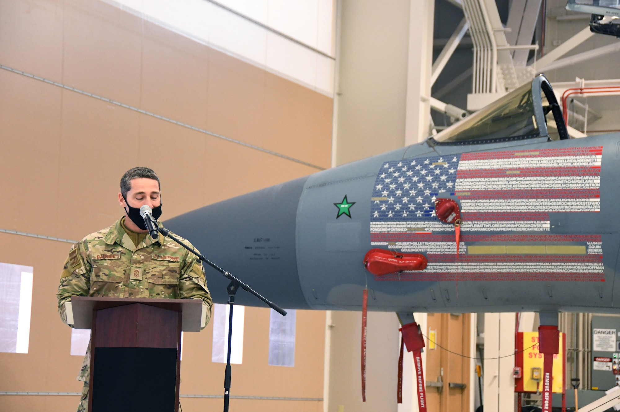 Chief Master Sgt. Paul Barbee, 104th Fighter Wing Command Chief, reads the names of award winners during the Annual Awards ceremony at Barnes Air National Guard Base, Massachusetts, Feb. 7, 2021. This ceremony recognized the 104FW’s top performers in 2020. (U.S. Air National Guard photo by Staff Sgt. Hanna Smith)