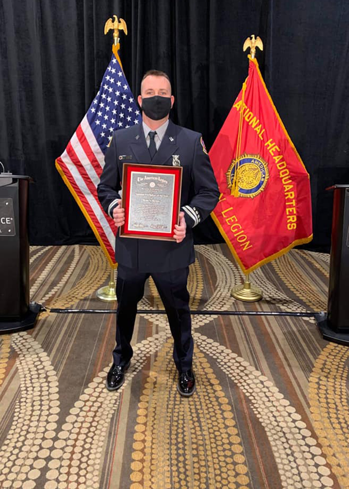 Firefighter poses with an award