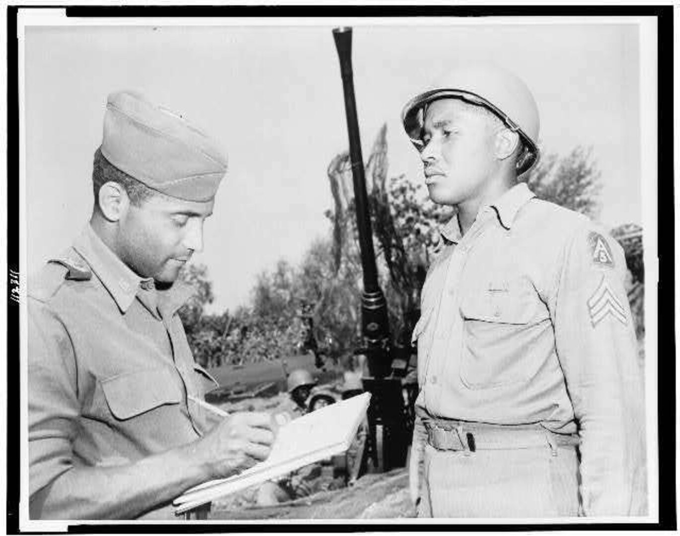 Oliver W. Harrington, a New York City artist correspondent, sketches anti-aircraft section chief, Sgt. Carl K. Hilton of Pine Bluff, Arkansas, who is with the Fifth Army in Italy in1944.