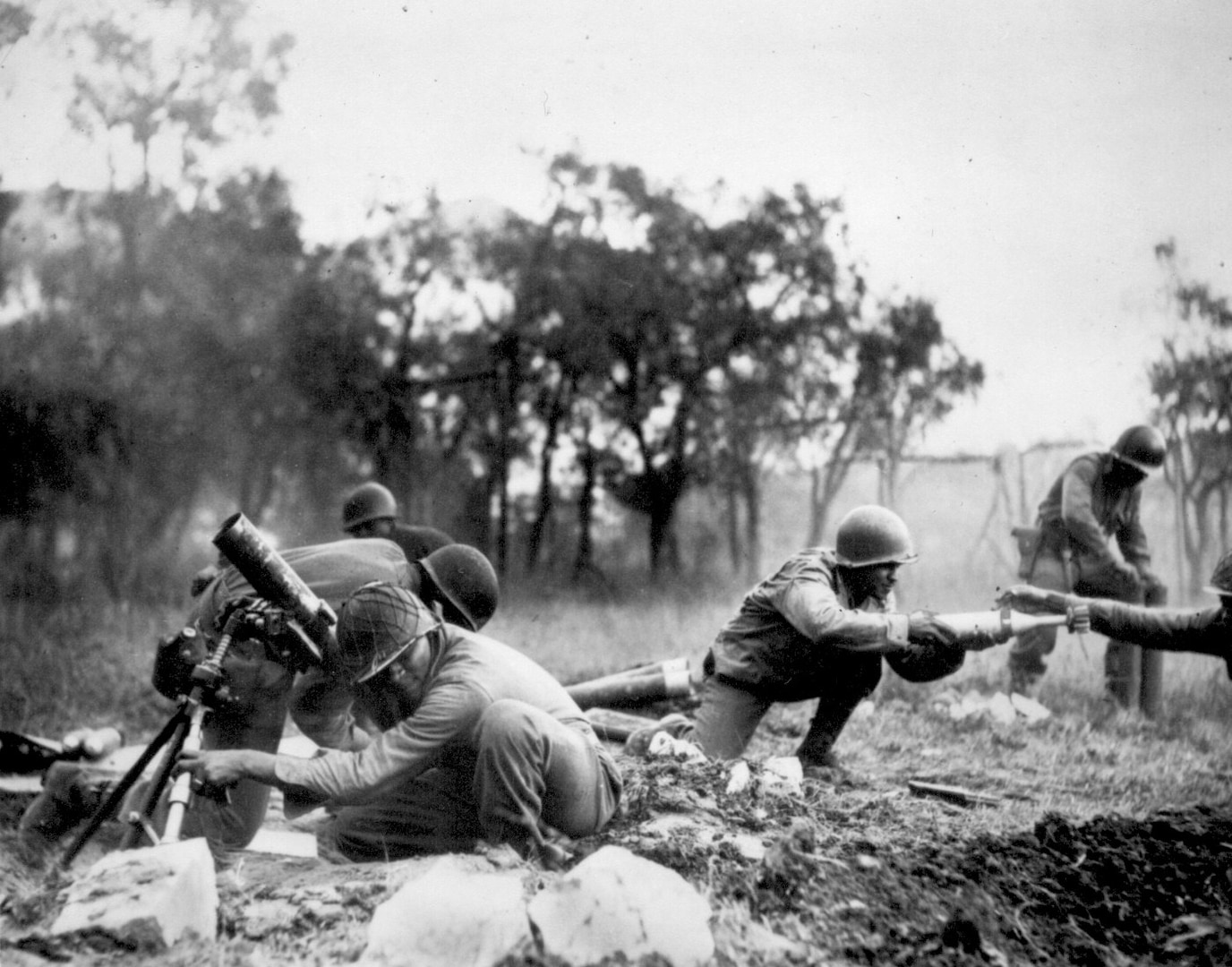 A mortar company of the 92nd Infantry Division passes ammunition and heaves it toward the Germans in an almost endless stream near Massa, Italy.