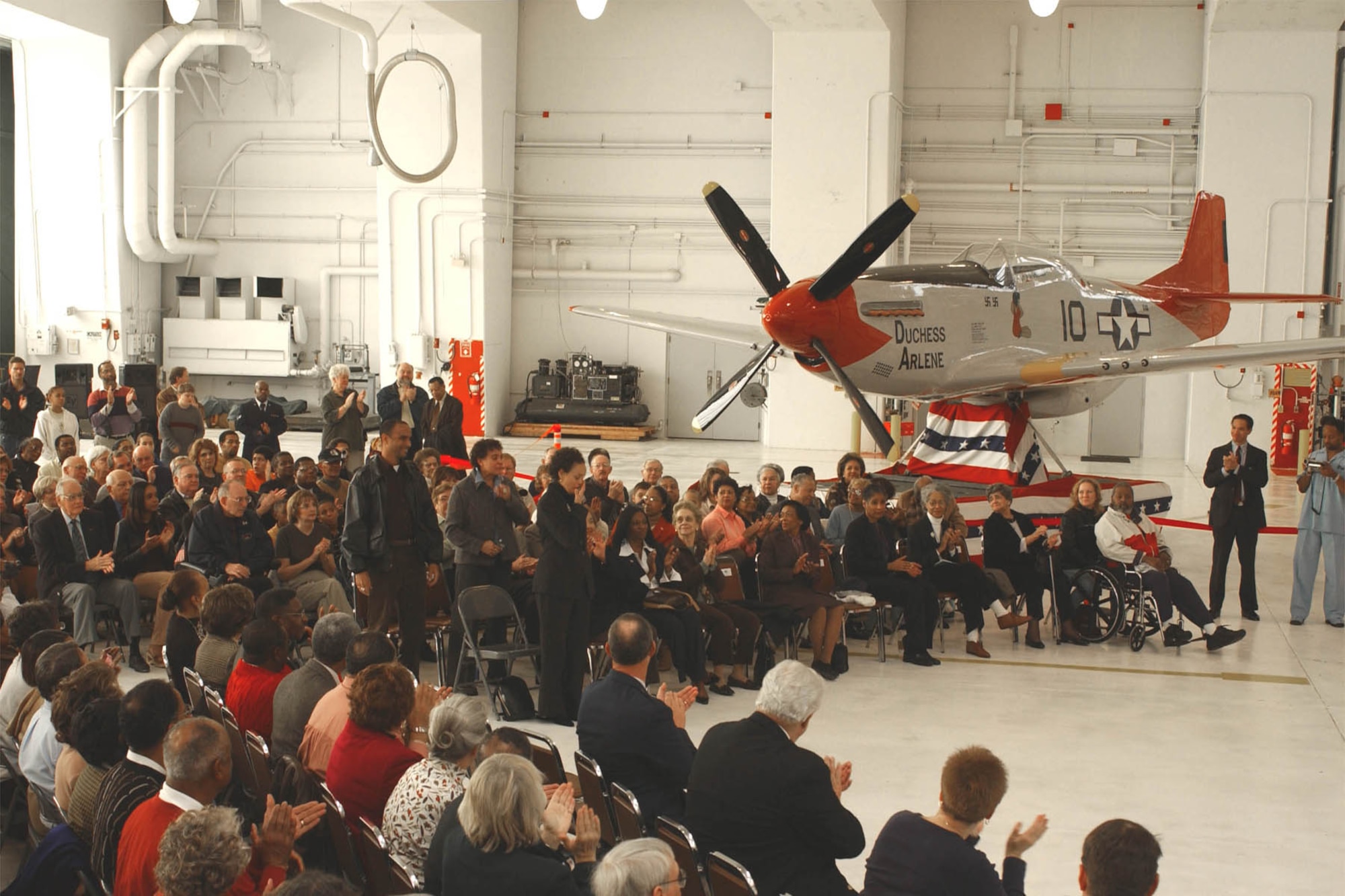 Friends and family of Iowa's Tuskegee Airmen gather to witness the dedication of the 132d Wing's P-51 Mustang static display. (Courtesy photo)