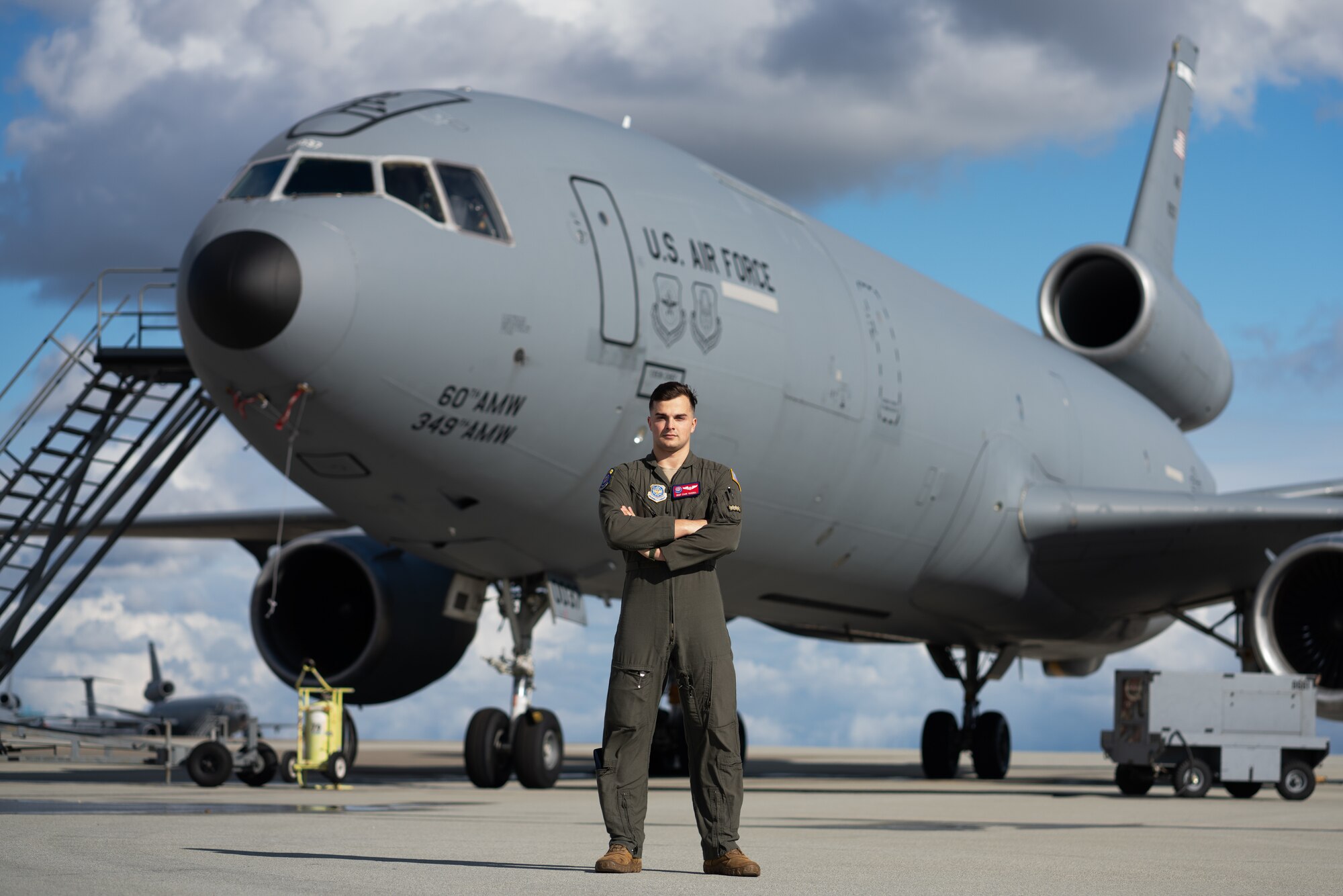 Airman posing for photo in front of an aircraft