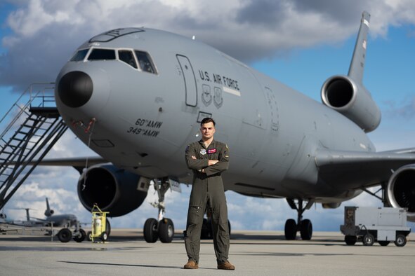 Airman posing for photo in front of an aircraft