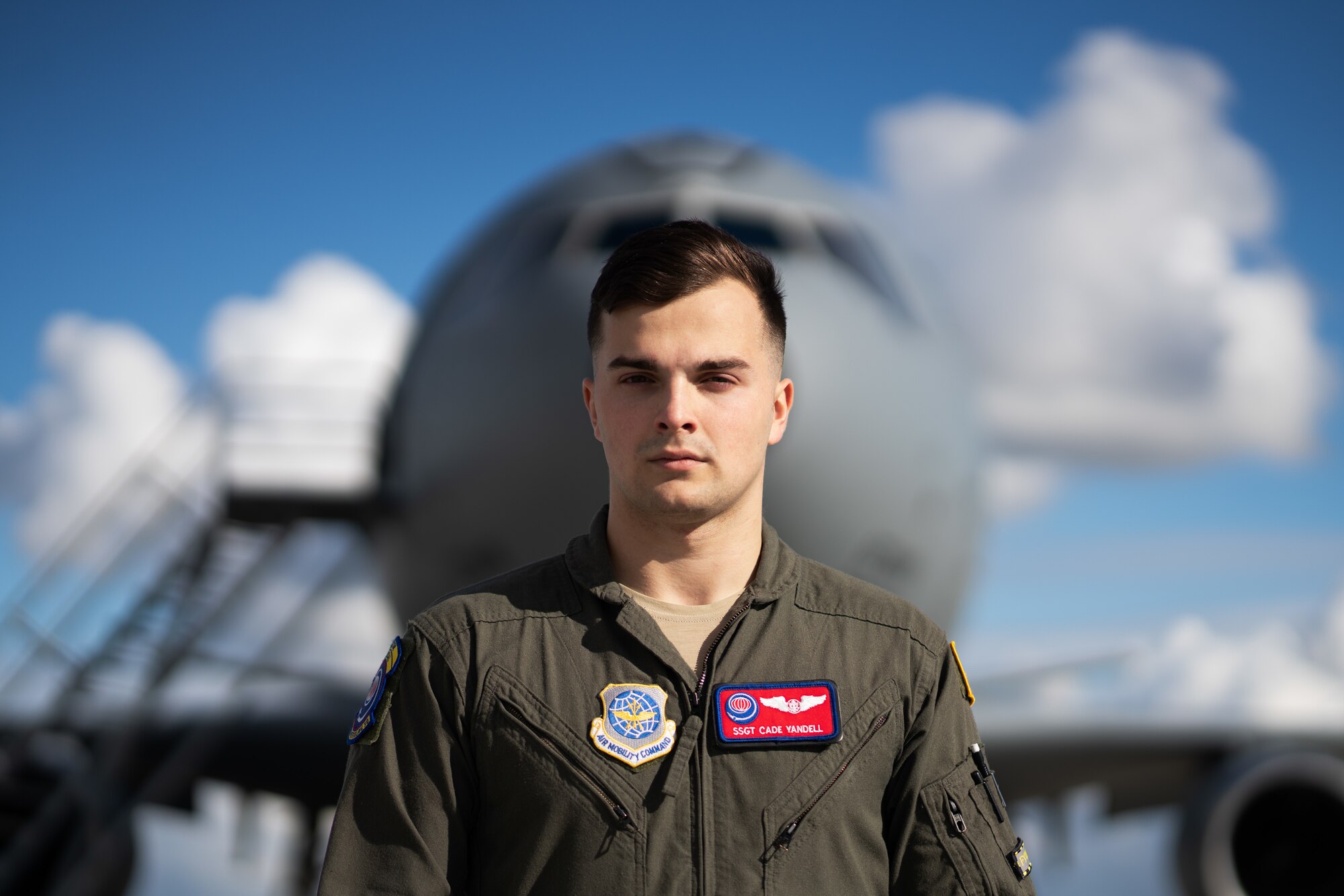 Airman posing for photo in front of an aircraft